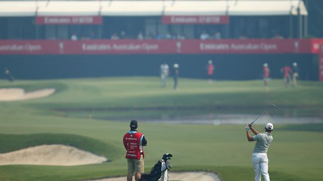 Hayden Hopewell plays an approach shot through the smoke haze at the Australian Open on Thursday. Picture: Getty Images