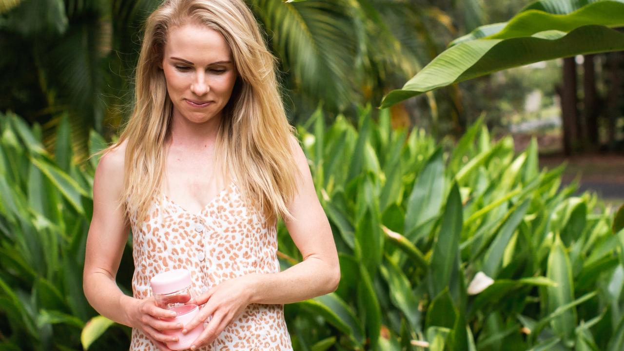 Sandra-Lea Murray holding one of her reusable Luxey coffee cups