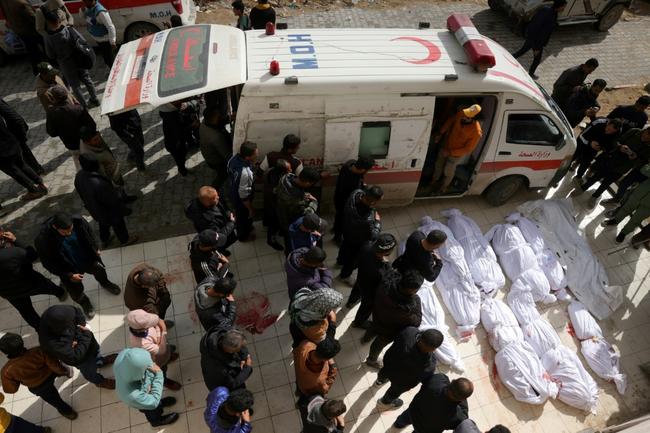 Palestinians gather around bodies outside the Indonesian Hospital in northern Gaza