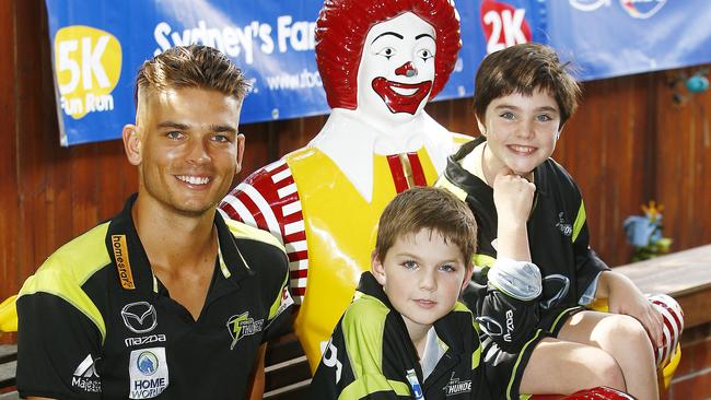 Ronald McDonald House Charities ambassador Chris Green from the Sydney Thunder with Carlo Moore, 11, and his sister Grace Moore, 9, at Ronald McDonald House, Randwick. Picture: John Appleyard