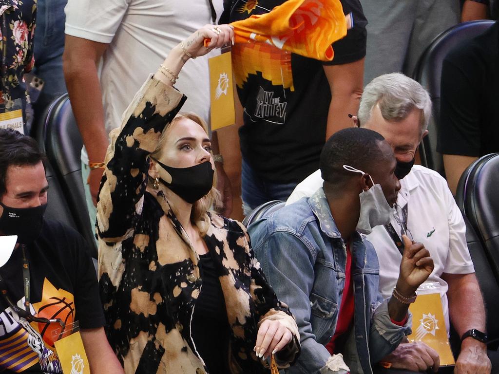 Adele waves a rally towel during the second half in Game Five of the NBA Finals. Picture: Christian Petersen/Getty Images