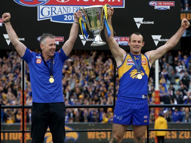 Adam Simpson and Shannon Hurn lift the cup. Picture: Michael Klein