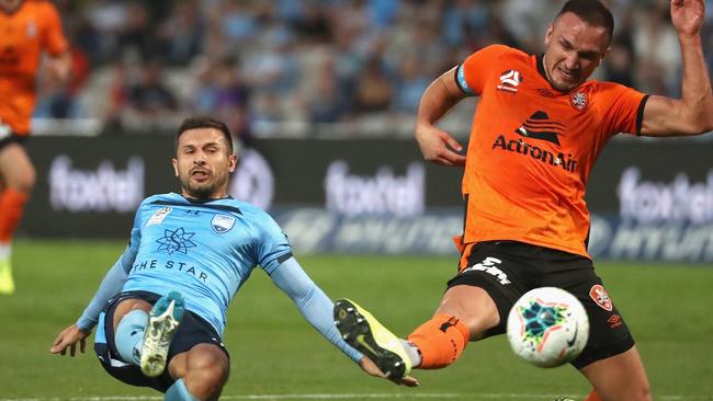 Kosta Barbarouses of Sydney FC and captain of the Roar Tom Aldred challenge for the ball during the Round 9 A-League match between Sydney FC and Brisbane Roar.