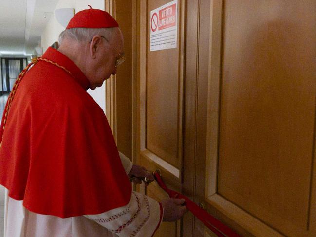 EDITORS NOTE: Graphic content / This photo taken on April 21, 2025 and handout on April 22, 2025 by The Vatican Media shows Cardinal Kevin Joseph Farrell, checking the sealed apartment of Pope Francis at Santa Marta in The Vatican. (Photo by Handout / VATICAN MEDIA / AFP) / RESTRICTED TO EDITORIAL USE - MANDATORY CREDIT 