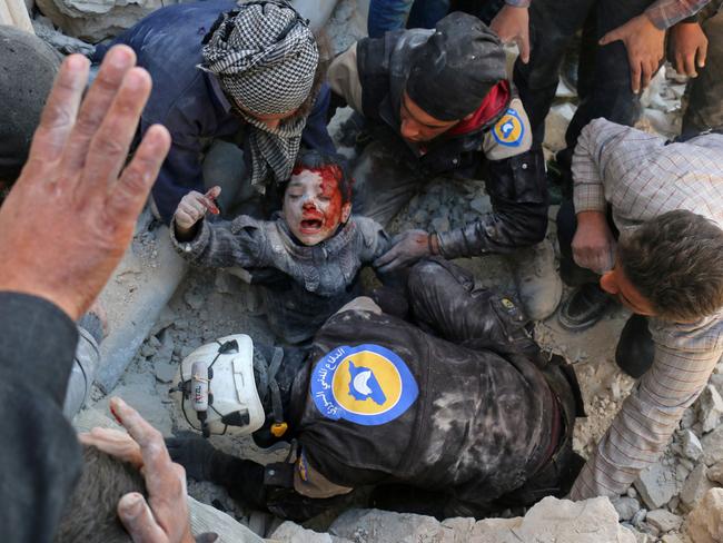 AFP PICTURES OF THE YEAR 2016 Syrian civil defence volunteers, known as the White Helmets, rescue a boy from the rubble following a reported barrel bomb attack on the Bab al-Nairab neighbourhood of the northern Syrian city of Aleppo on November 24, 2016.Photo: AFP/ AMEER ALHALBI