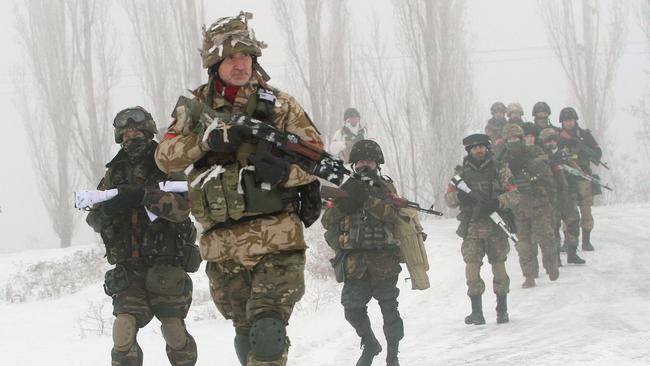 Ukrainian servicemen of the Donbass volunteer battalion take part in clean-up operations in a village in the Lysychansk district of the Lugansk region.