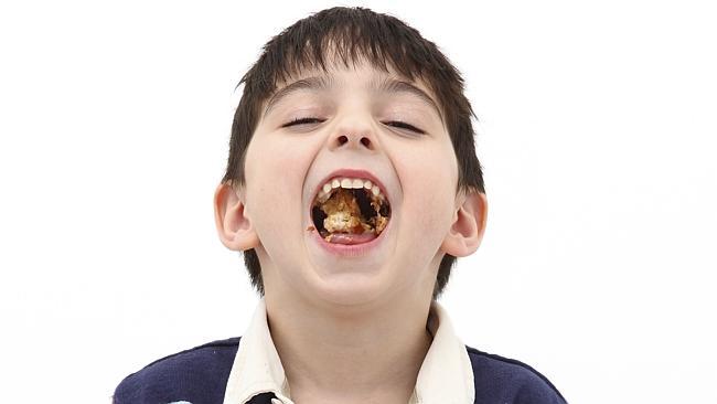Adorable five year old boy making peanut butter and jelly sandwiches. Jam. Eating. Open mouth. Food. Child. Kids. Children. ...