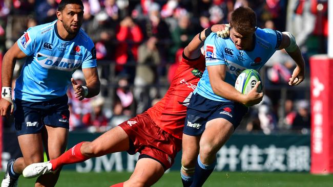 Waratahs centre Alex Newsome tries to shrug off a Sunwolves tackler on Saturday. Picture: Getty Images 