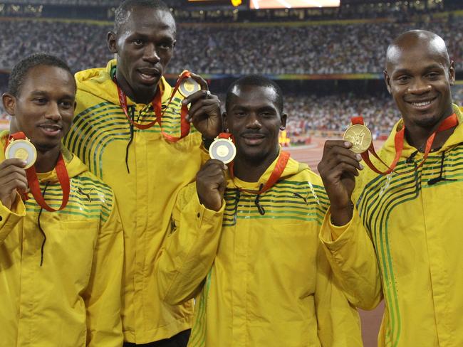 Michael Frater, Usain Bolt, Nesta Carter and Asafa Powell show their gold medals during the athletics competitions in the National Stadium at the Beijing 2008 Olympics in Beijing. Picture:  AP