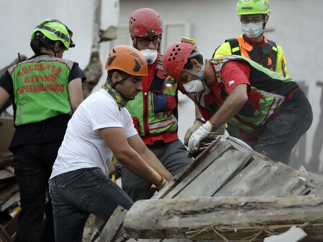 Rescuers search through debris for signs of life. Picture: AP/Andrew Medichini