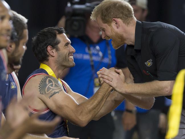 Prince Harry congratulates a military veteran at the Invictus Games. Picture: Supplied