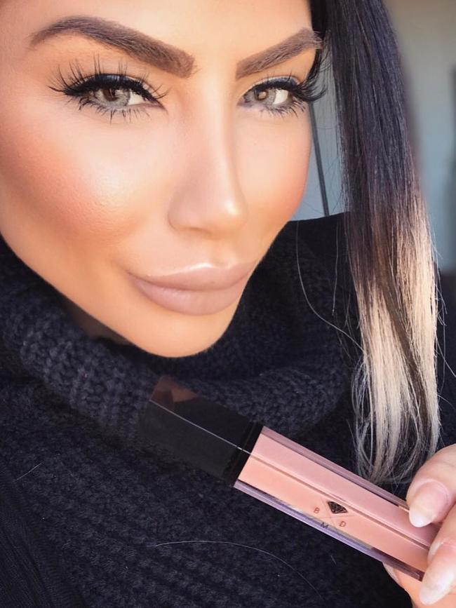 Dolled up to the max, Aisha Mehajer promotes some lip gloss... 
