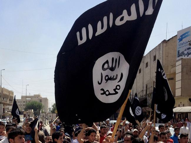 FILE - In this Monday, June 16, 2014 file photo, demonstrators chant pro-Islamic State group slogans as they wave the group's flags in front of the provincial government headquarters in Mosul, 225 miles (360 kilometers) northwest of Baghdad, Iraq. (AP Photo, File)