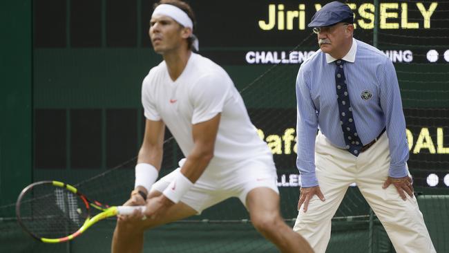 A linesman watches as Rafael Nadal of Spain plays in his men's singles match at Wimbledon.