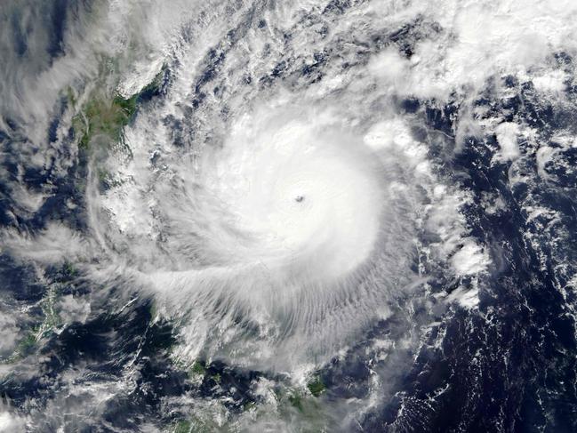 This December 25, 2016 NASA satellite images shows Super Typhoon Nock-ten (30W) over the Philippines. A powerful typhoon with gusts of up to 235 kilometres (146 miles) an hour hit the Philippines late Sunday, disrupting Christmas celebrations for tens of thousands who fled its approach, officials said. Typhoon Nock-Ten made landfall in the eastern island province of Catanduanes at 6:30 pm (1030 GMT), the state weather service said. There were no immediate official reports of damage or casualties from the storm, one of the strongest this year to hit the disaster-prone archipelago on the Pacific Rim. / AFP PHOTO / NASA / HO
