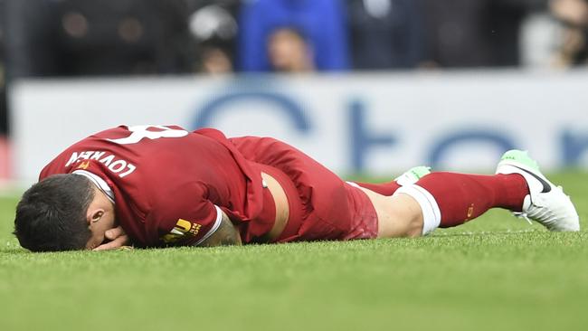 Liverpool's Croatian defender Dejan Lovren lies injured after a tangle with  Manchester United's Belgian striker Romelu Lukaku during the English Premier League football match between Liverpool and Manchester United at Anfield in Liverpool, north west England on October 14, 2017. / AFP PHOTO / Paul ELLIS / RESTRICTED TO EDITORIAL USE. No use with unauthorized audio, video, data, fixture lists, club/league logos or 'live' services. Online in-match use limited to 75 images, no video emulation. No use in betting, games or single club/league/player publications.  /