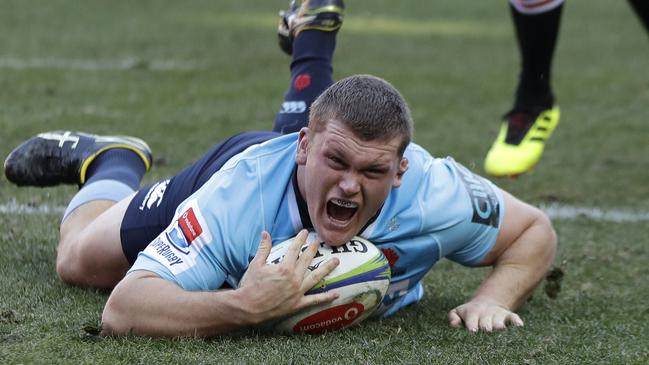 Waratahs prop Tom Robertson scores a try against the Lions on Saturday night.