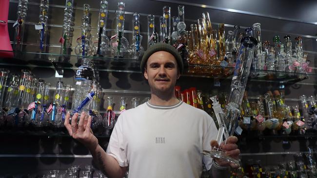 Chris Burn in his shop in Canberra called Mullep with one of his most popular bongs, the Powerbeug. Picture: Gary Ramage