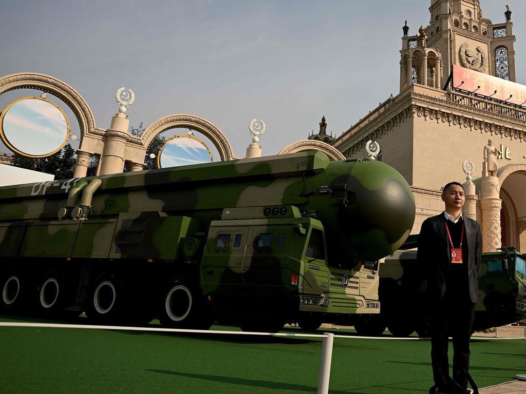 A man poses in front of a Dongfeng-41 intercontinental ballistic missile in China. Picture: Noel Celis/AFP