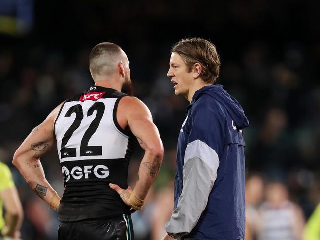 ADELAIDE, AUSTRALIA – JULY 23: Charlie Dixon of the Power talks to Rhys Stanley of the Cats after the match. Stanley retired hurt during the 2022 AFL Round 19 match between the Port Adelaide Power and the Geelong Cats at Adelaide Oval on July 23, 2022 in Adelaide, Australia. (Photo by Sarah Reed/AFL Photos via Getty Images)