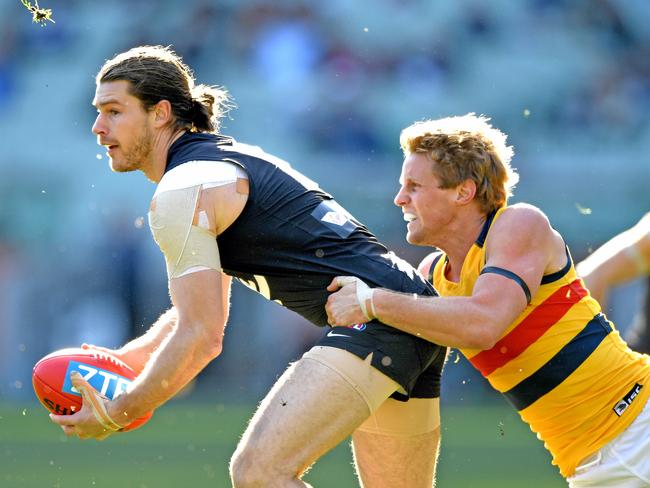 Carlton’s Bryce Gibbs shakes off Adelaide’s Rory Sloane during Saturday’s clash at the MCG. Picture: AAP Image/Joe Castro