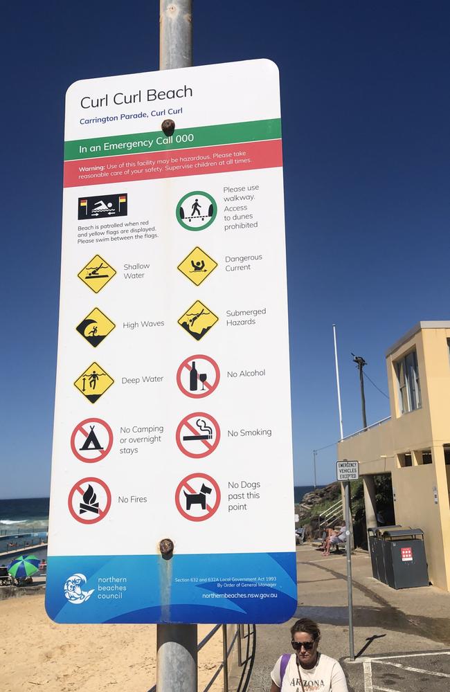 A beach hazards sign, up a pole, at the southern end of Curl Curl Beach. Picture: Jim O'Rourke