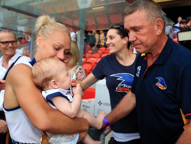 Erin Phillips and baby Blake with and Erin's dad Greg celebrates winning the Women's AFLW Grand Final between the Brisbane Lions and Adelaide Crows at Metricon Stadium on the Gold Coast. Pics Adam Head