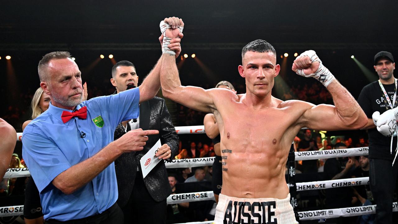 Harry Garside gets his hand raised after the stoppage win. Pictures: No Limit Boxing/Gregg Porteous