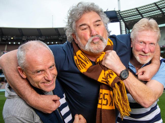 AFL greats Andrew Bews, Robert 'Dipper' DiPierdomenico and Neville Bruns re-enact a 1989 Grand final moment on the members wing at the MCG. Picture: Mark Stewart