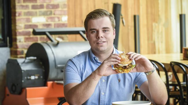 Pickled Duck owner Nick King with the popular Aussie burger. Picture: AAP/Roy VanDerVegt