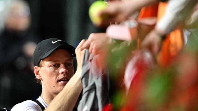 Italy's Jannik Sinner signs autographs as he leaves the court after a training session at Foro Italico sports complex, ahead of the Italian Open tennis tournament, in Rome on May 5, 2025. (Photo by Tiziana FABI / AFP)