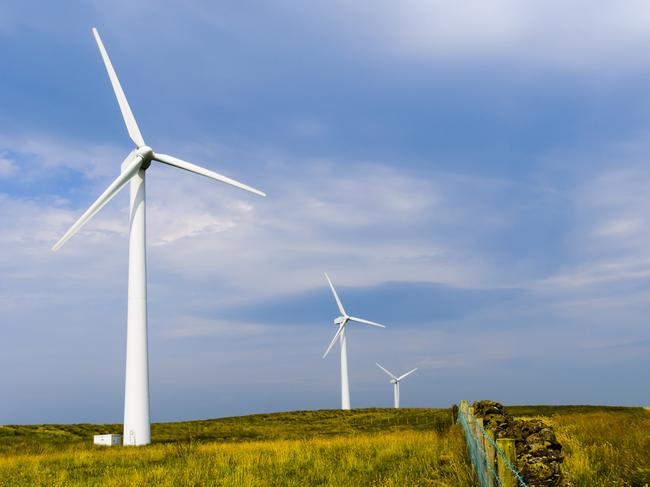 Silhouetted wind turbine at a rural windfarm.