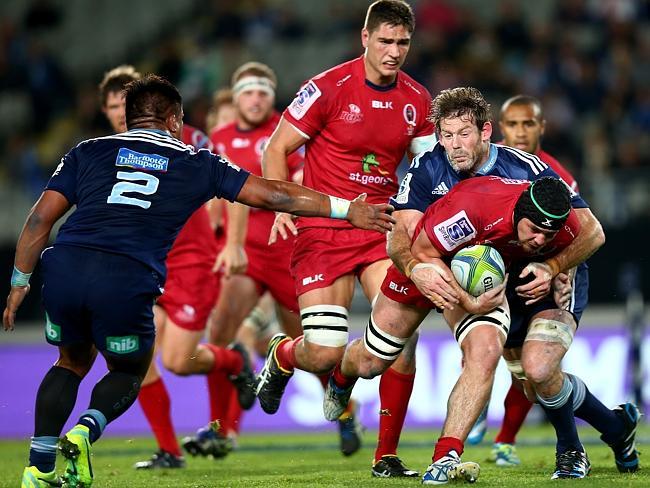 Liam Gill is tackled by Tom Donnelly as Keven Mealamu comes in to lend a hand in defence.
