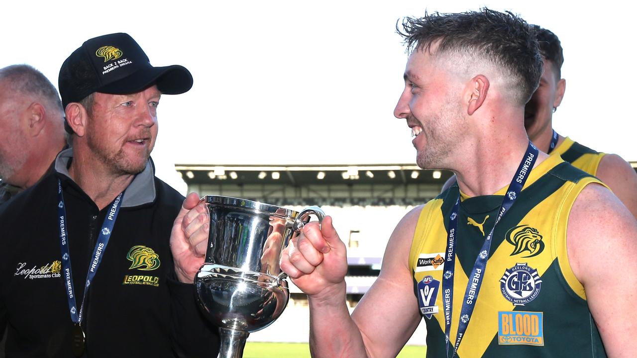 GFNL Grand Finals. Seniors. South Barwon v Leopold. Leopold Captain Marcus Thompson celebrates with the Coach Garry Hocking and the priemership trophy. Picture: Mike Dugdale