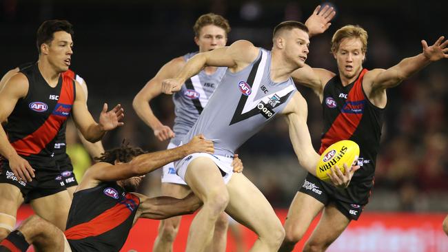 Peter Ladhams fires out a handpass against the Bombers. Picture: Michael Klein