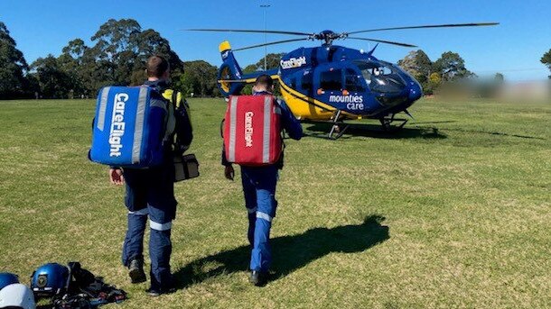 A CareFlight team attend to a toddler who suffered burns on a property at Elanora Heights. Picture: Supplied.