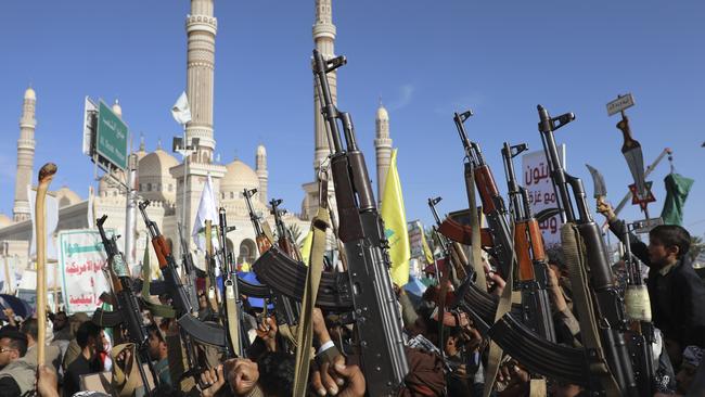 Houthi supporters raise their machine guns during an anti-US and Israel rally in Sanaa, Yemen, in November. Picture: AP