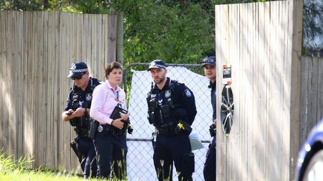 Police attend a Logan address after Energex worker Kane Minion was mauled to death by two dogs in 2022.