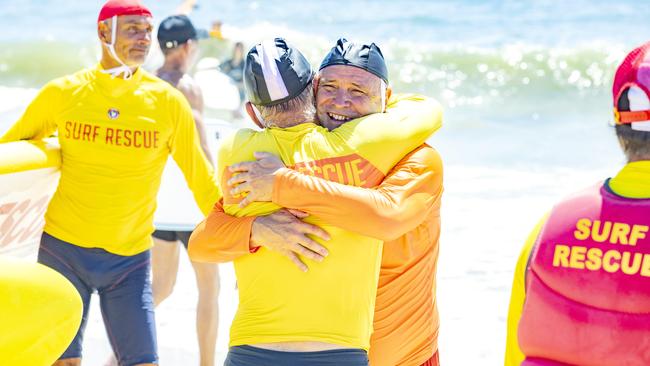 Steve Zmuda embraces a friend at the memorial. Picture: Richard Walker