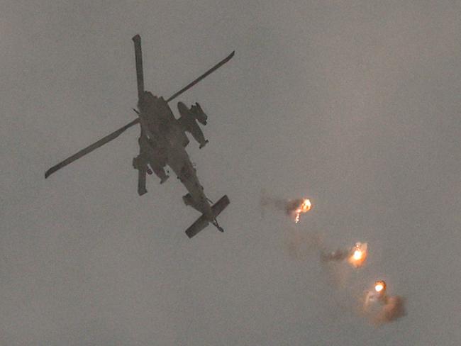 An Israeli air force attack helicopter releases flares while flying in an area along the border with the Gaza Strip and southern Israel. Picture: AFP