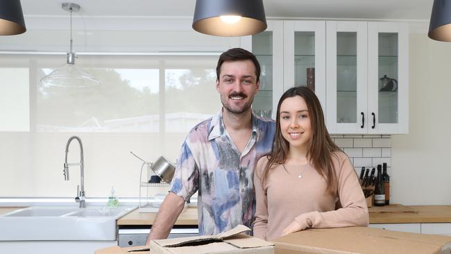 Jarrod Redmond, 23, and Rebecca Michelsen, 21, pose for a photo at their new home. The young couple have successfully bought their first home at in Emu Heights. Pic: AAP Image/David Swift