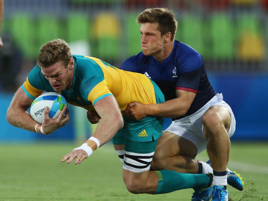 Tom Cusack of Australia is tackled by Stephen Parez of France during the men’s rugby sevens match that saw the Aussies lose and place eighth overall.