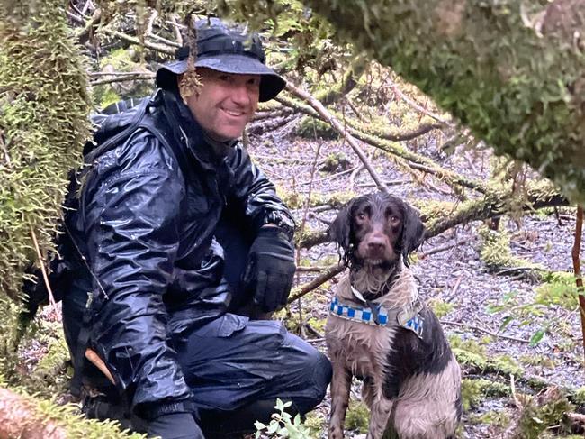 NSW Police dog handler Senior Constable Chris Hill, and 5-year-old cadaver dog, Wags searching for missing Belgian tourist Celine Cremer at Philosopher Falls on Tasmania's West Coast. Picture: Tasmania Police