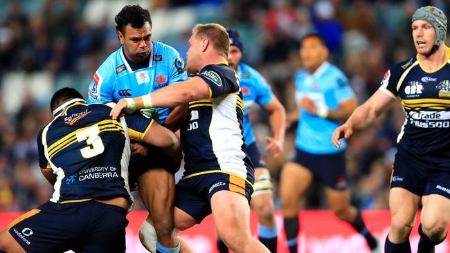 Waratahs star Kurtley Beale is tackled on Saturday night.
