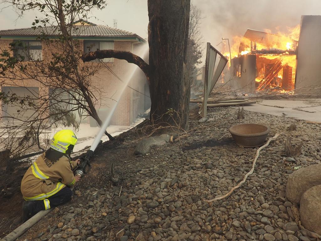 A bush fire rages in the town of Tathra on Sunday afternoon, March 18, 2018. Picture: John Ford