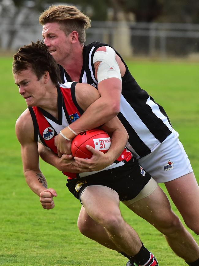 Rockbank’s Saxon Woodraffe gets caught in a tackle againt Wallan on Saturday. Picture: Dennis Manktelow