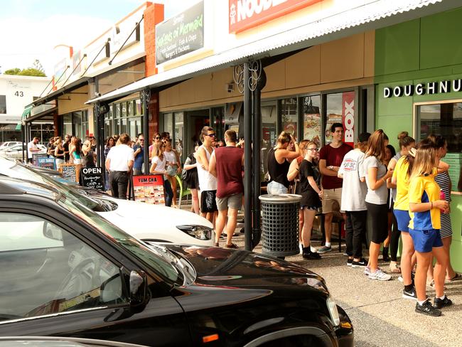 People queuing for the free doughnuts at the new doughnut shop 'dougnhnuttime' at Mermaid Beach . 18 year old Dana Steele .Picture Mike Batterham