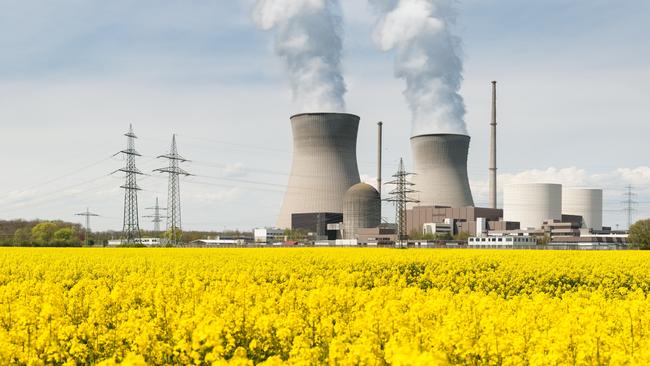 A nuclear power plant overlooks a yellow field in Germany.