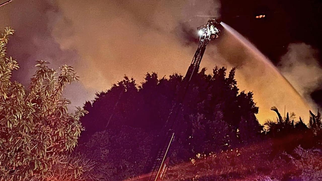 Firefighters shoot water onto the properties. Picture: QAS via NCA NewsWire