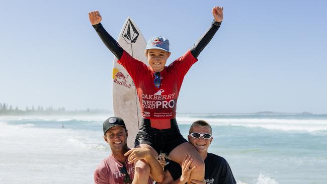 Sierra Kerr with her dad Josh (bottom left) celebrating after winning the Tweed Coast Pro Junior at Kingscliff. (Photo by Cait Miers/World Surf League)